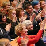 The TEDxSnoIsleLibraries audience applauds author Dawn Shaw, who spoke about how her facial difference affects her life and perspective. (Photo by Merlin Quiggle for Sno-Isle Libraries)