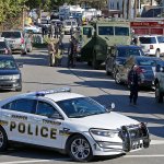Police vehicles line streets of a neighborhood in Canonsburg, Pennsylvania, where two police officers were shot when they responded to a domestic call early Thursday, Nov. 10. (AP Photo/Gene J. Puskar)