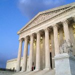 People stand on the steps of the Supreme Court at sunset in Washington. (AP Photo/Jon Elswick, Feb. 13, 2016 file)