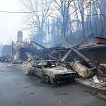 A structure and vehicle are damaged from the wildfires around Gatlinburg, Tennessee, on Tuesday, Nov. 29. Rain had begun to fall in some areas, but experts predicted it would not be enough to end the relentless drought that has spread across several Southern states and provided fuel for fires now burning for weeks in states including Tennessee, Georgia and North Carolina. (Michael Patrick/Knoxville News Sentinel via AP)