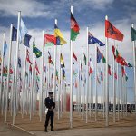A member of Moroccan security stands guard next to flags of participating UN member states, on the entrance to the COP22 village, a day ahead of the opening ceremony, in Marrakesh, Morocco, on Sunday, Nov. 6. The Climate Conference, known as the COP22, starts Monday in Marrakech. (AP Photo/Mosa&rsquo;ab Elshamy)