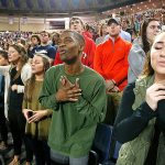 In this Oct. 12 photo, Liberty University students sing and pray prior to a speech by Republican vice presidential candidate, Indiana Gov. Mike Pence, at Liberty University in Lynchburg, Virgina. Evangelicals, deeply divided over Republican presidential candidate Donald Trump, are wrestling with what the tumultuous 2016 election will mean for their future. (AP Photo/Steve Helber)