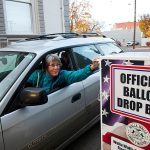 A driver drops her ballot off in an alley on South Fourth Avenue in Walla Walla, on Monday, Nov. 7. (Michael Lopez/Walla Walla Union-Bulletin via AP)