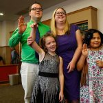 Nick and Erin Schramm gladly raise their right hands (and Miah&rsquo;s) before Superior Court Judge David A. Kurtz on Friday morning as they adopt Kortnei, 9 (right) and Miah, 8, making them a very happy family of four. (Dan Bates / The Herald)