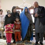 Afghan President Ashraf Ghani, right, poses for photographers during a meeting with National Geographic&rsquo;s famed green-eyed &ldquo;Afghan Girl,&rdquo; Sharbat Gulla, and family, at the Presidential palace in Kabul, Afghanistan, on Nov. 9. (AP Photo/Rahmat Gul)