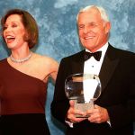 In this 1997 photo, Television executive Grant Tinker holds up his Hall of Fame award alongside his ex-wife, Mary Tyler Moore, at the Academy of Television Arts & Sciences&rsquo; 13th Annual Hall of Fame induction ceremonies in the North Hollywood section of Los Angeles. Tinker, who brought &ldquo;The Mary Tyler Moore Show&rdquo; and other hits to the screen as a producer and a network boss, died Monday, Nov. 28, at his home in Los Angeles, according to his son, Mark Tinker. (AP Photo/Chris Pizzello, File)