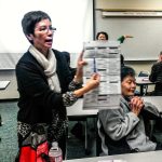 Nia Bell, who speaks Vietnamese, explains and answers questions about the ballot during the event. (Julie Muhlstein / The Herald)