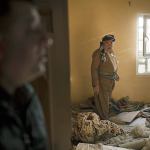 Khan Amir walks inside his house, that was being used by Islamic State militants, after it was retaken by Kurdish Peshmerga in Bashiqa, east of Mosul, Iraq, on Friday, Nov. 11. Iraqi troops inched ahead in their battle to retake the northern city of Mosul from the Islamic State group on Friday, as the U.N. revealed fresh evidence that the extremists have used chemical weapons. (AP Photo/Felipe Dana)