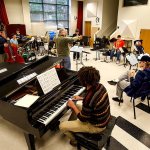 Edmonds Community College jazz band director John Sanders (standing center) leads a rehearsal Monday of jazz and salsa band students at Edmonds Community College, which is trying to raise money to attend the Fiesta del Tambor in Havana this March. Dan Bates / The Herald