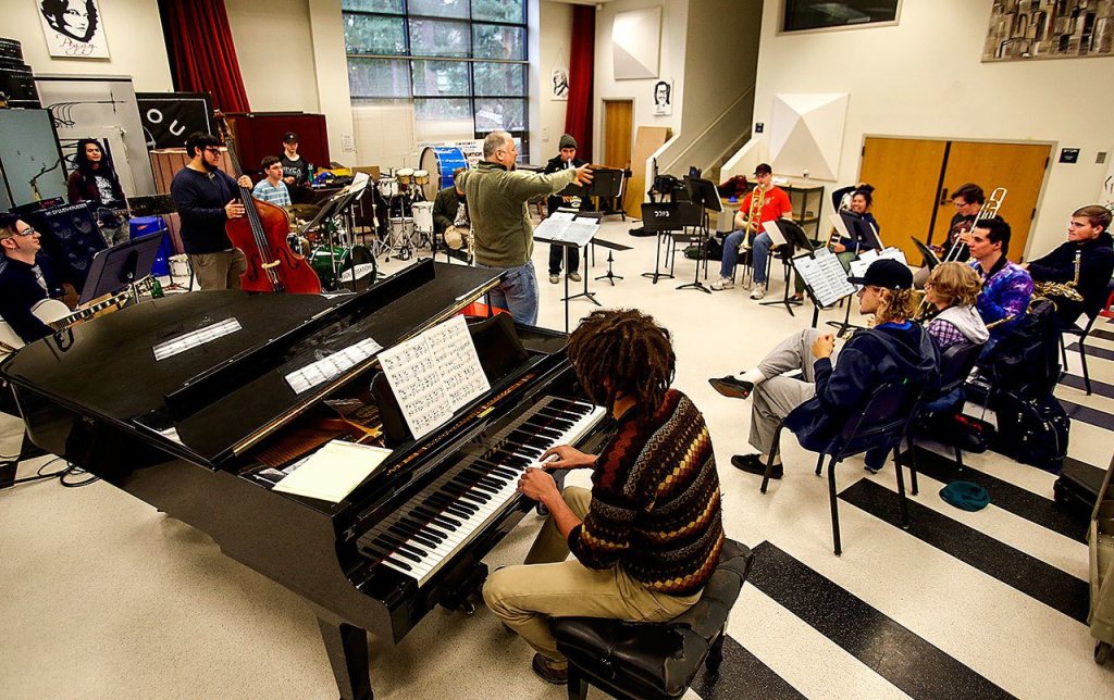 Edmonds Community College jazz band director John Sanders (standing center) leads a rehearsal Monday of jazz and salsa band students at Edmonds Community College, which is trying to raise money to attend the Fiesta del Tambor in Havana this March. Dan Bates / The Herald
