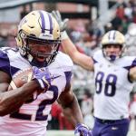 Washington running back Lavon Coleman runs into the end zone for a touchdown with tight end Drew Sample celebrating during the Apple Cup against Washington State on Friday afternoon in Pullman. (Kevin Clark / The Herald)