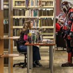 Chloe Taton, left, talks with Shane Harris during the Sno-Isle ComicCon on Sunday morning at the Snohomish Library. (Kevin Clark / The Herald)