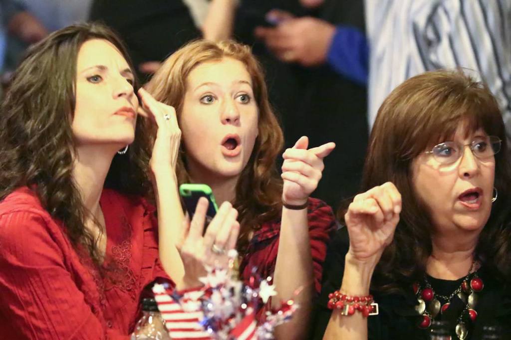 Republican supporters react to numbers coming in at the Snohomish Event Center on Tuesday. (Kevin Clark / The Herald)