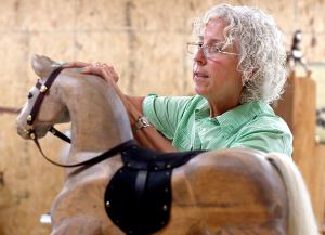 Artist Jackie Wilson of Oklahoma this week delivered to Imagine Children&rsquo;s Museum a wood horse similar to the pony she is working on in this photo. The horse is now in the Rise and Shine Farm exhibit at the museum. Wilson gained international attention when one of her rocking horses was purchased as a birthday gift to the royal tot Prince George.