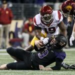 Washington quarterback Jake Browning is sacked by Southern California linebacker Michael Hutchings (left) with help from Southern California linebacker Cameron Smith on Saturday night at Husky Stadium in Seattle. (Kevin Clark / The Herald)