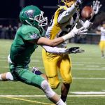 Woodinville&rsquo;s Nash Fouch makes a reception past the outstretched arms of Mariner&rsquo;s Tyrone Jones during a 4A state playoff game at Pop Keeney Stadium in Bothell on November 11, 2016. (Kevin Clark / The Herald)