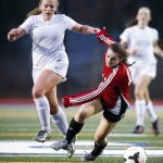 Snohomish&rsquo;s Taylor Dewing (right) is taken down by Stanwood&rsquo;s Sarah Schafer during a district playoff game Tuesday at Shoreline Stadium. (Ian Terry / The Herald)