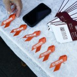 Orange pins adorn a table setup to promote Zonta International, a group dedicated to raising awareness about violence towards women, during a get-together for the group&rsquo;s local Everett chapter on Friday. (Ian Terry / The Herald)