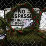 Wreaths hang on a fence near the railroad tracks on the west end of Hewitt Avenue in Everett with the names of victims of the Everett Massacre. (Ian Terry / The Herald)