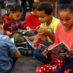 Kindergarteners (from left) Asher Wheatley, Quentin Cook, Iokua Baker, Elijah Stewart and Cai Williams-Smith dive right into the new books. The books are part of a $35,000 gift of supplies from Inspirus Credit Union to the Edmonds School District. (Dan Bates / The Herald)