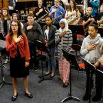 North Middle School band and choir director, Emily Cheever leads her class saluting the flag at the start of the day, June 15. (Dan Bates / The Herald)