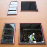 Glazier Ben Challman measures a window sill at the new Lakewood High School on Tuesday, Nov. 22, 2016 in Lakewood, Wa. (Andy Bronson / The Herald)