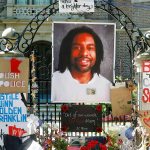 In this July 25, 2016, photo, a memorial including a photo of Philando Castile adorns the gate to the governor&rsquo;s residence where protesters continue to demonstrate in St. Paul, Minnesota, against the July 6 shooting death of Castile by St. Anthony police officer Jeronimo Yanez during a traffic stop. (AP Photo/Jim Mone, File)