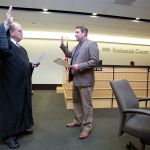 Snohomish County Superior Court Judge Thomas Wynne administers the oath of office to new County Councilman Sam Low on Tuesday in Everett. (Andy Bronson / The Herald)