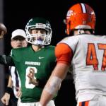Edmonds-Woodway&rsquo;s Kameron Krall drops back to pass with Lakes&rsquo; Cale Lindsay closing during a 3A playoff game Friday night at Edmonds Stadium. Lakes won 21-14. (Kevin Clark / The Herald)