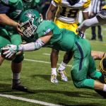 Woodinville&rsquo;s Mack Minnehan stretches for the goal line with Mariner&rsquo;s Cayden Herbert attempting a stop during a 4A state playoff game at Pop Keeney Stadium in Bothell on November 11, 2016. (Kevin Clark / The Herald)