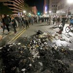 Protesters march past burned garbage in downtown Oakland, California, on Wednesday, Nov. 9. President-elect Donald Trump&rsquo;s victory set off multiple protests. (Jane Tyska/Bay Area News Group via AP)