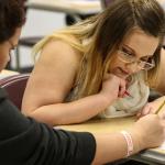 Rhianna Conrad (left) helps Jessiana King with her math during class at Crossroads Higs School in Granite Falls. King is taking part in the GRADS program for teen parents as a full-time student. (Kevin Clark / The Herald)