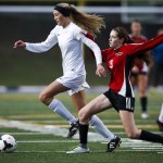 Snohomish&rsquo;s Mackenzie Green (right) tries to stop a charging Anna DePew of Stanwood during a district playoff game Tuesday at Shoreline Stadium. (Ian Terry / The Herald)