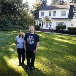 Jill Brumbaugh and her son, Joel Lidstrom, stand on the front lawn outside of their 4,000-square-foot renovated home in Monroe. (Ian Terry / The Herald)