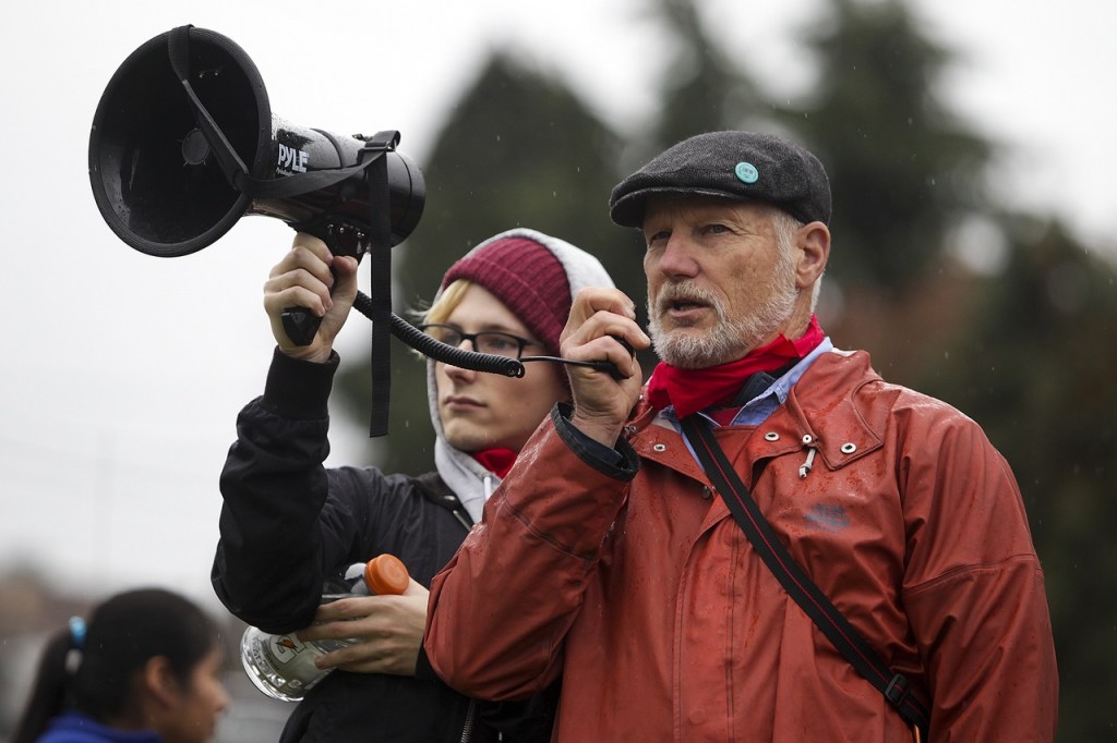 Industrial Workers of the World member Dave Tucker (right), of Bellingham, speaks to a small crowd gathered Saturday afternoon in Everett to remember the 100 year anniversary of the Everett Massacre. (Ian Terry / The Herald)