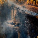 A flame continues to burn after a Monday explosion of a Colonial Pipeline, on Tuesday, Nov. 1, in Helena, Alabama. The blast, which sent flames and thick black smoke soaring over the forest, happened about a mile west of where the pipeline ruptured in September, Gov. Robert Bentley said in a statement. (AP Photo/Brynn Anderson)
