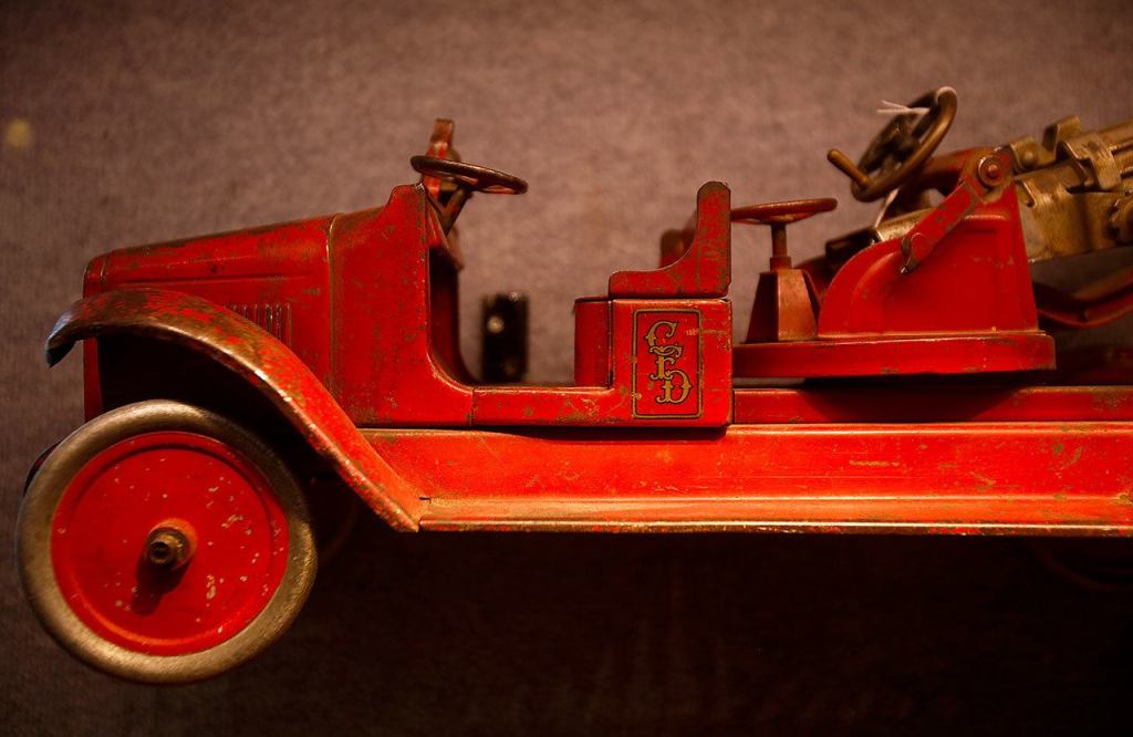 An old-time fire truck occupies a parking space in the Edmonds Historical Museum&rsquo;s &ldquo;Once Upon a Toy&rdquo; exhibit. (Dan Bates / The Herald)
