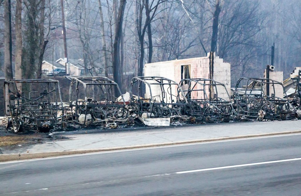 Burned out frames side-by-side utility vehicles sit at the side of the road in Gatlinburg, Tennessee, on Tuesday, Nov. 29. The fatal wildfires swept over the tourist town the night before, causing widespread damage. (AP Photo/Erik Schelzig)