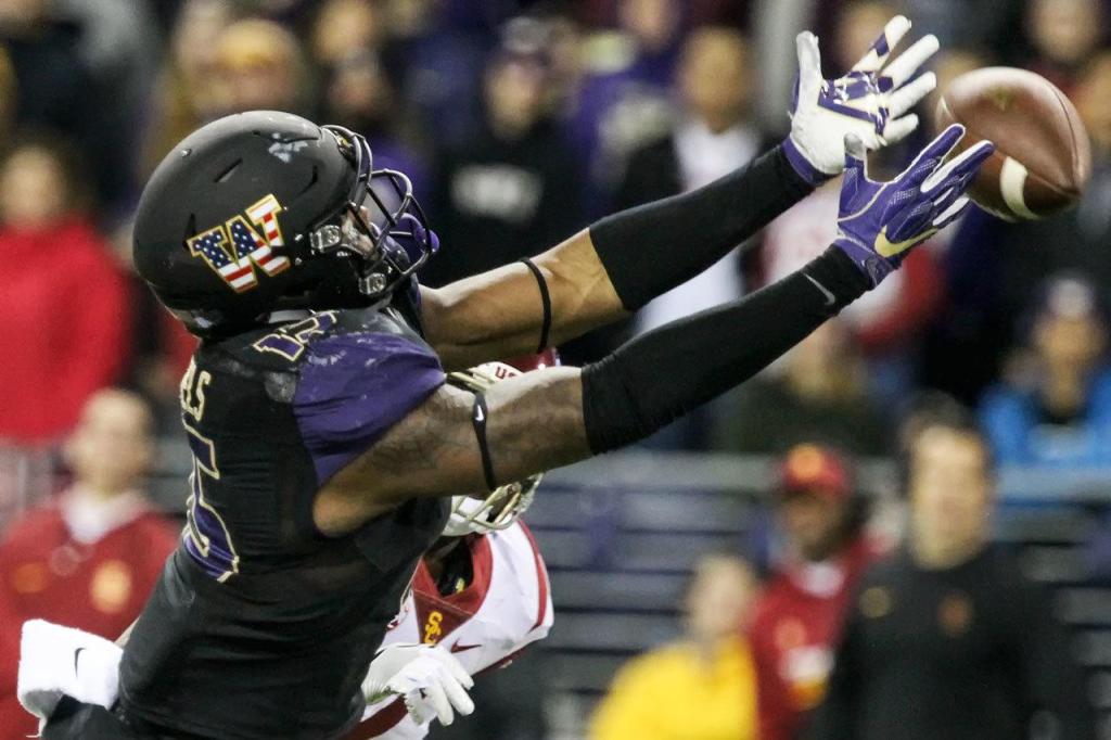Washington tight end Darrell Daniels reaches out for a reception against Southern California on Saturday night at Husky Stadium in Seattle. (Kevin Clark / The Herald)