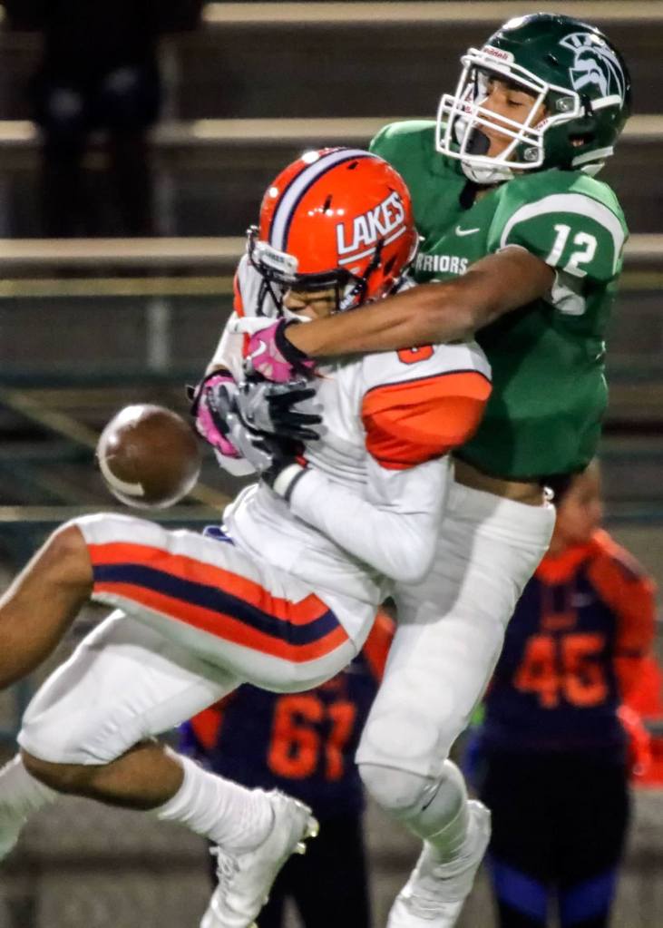 Lakes&rsquo; Cody Roe breaks up a pass intended for Edmonds-Woodway&rsquo;s Jaro Rouse during a 3A playoff game Friday night at Edmonds Stadium. Lakes won 21-14. (Kevin Clark / The Herald)