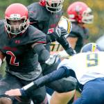 Archbishop Murphy&rsquo;s Emmanuel Osuoha rushes for additional yardage with Burlington-Edison&rsquo;s Hunter Anderson closing in during the Wildcats&rsquo; 55-6 victory over the Tigers in a 2A bi-district playoff game on Saturday in Everett. (Kevin Clark / The Herald)