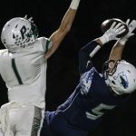 Meadowdale&rsquo;s Haelin Roberts makes a reception with Peninsula&rsquo;s Jack Filkins defending during a 3A state quarterfinal game Friday at Edmonds Stadium. (Kevin Clark / The Herald)