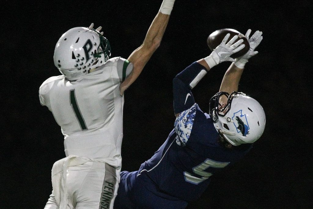 Meadowdale&rsquo;s Haelin Roberts makes a reception with Peninsula&rsquo;s Jack Filkins defending during a 3A state quarterfinal game Friday at Edmonds Stadium. (Kevin Clark / The Herald)