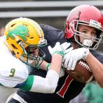 Archbishop Murphy&rsquo;s Collin Montez is hit by Lynden&rsquo;s Landon DeBruin as he crosses the goal line for a touchdown during a 2A state semifinal game Saturday afternoon at Everett Memorial Stadium. The Wildcats won 52-14. (Kevin Clark / The Herald)