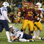 O&rsquo;Dea&rsquo;s Kyle Hollabaugh (42) celebrates a sack of Meadowdale&rsquo;s Drew Tingstad with Meadowdale&rsquo;s Bryce Chapman looking on during a 3A state semifinal game Saturday at Pop Keeney Stadium in Bothell. O&rsquo;Dea won 35-9. (Kevin Clark / The Herald)