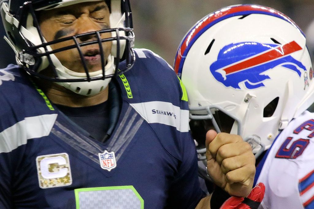 Seahawks quarterback Russell Wilson is hit by Bills linebacker Zach Brown after a pass attempt during Seattle&rsquo;s 31-25 win over Buffalo on Monday night. (Kevin Clark / The Herald)
