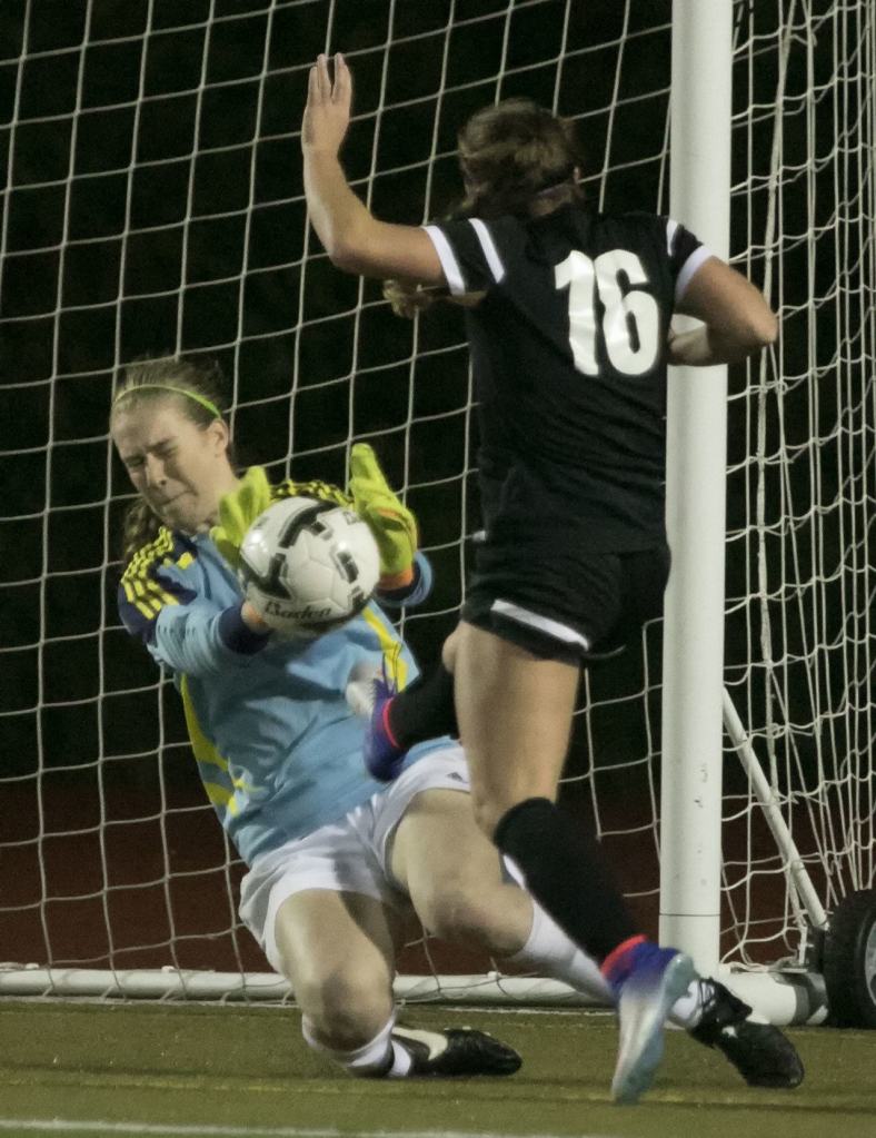 Jackson&rsquo;s Kayleigh Sedlacek blocks a shot attempt by Kamiak&rsquo;s Kailin Wiley during a district playoff match Thursday night Everett Memorial Stadium. (Kevin Clark / The Herald)