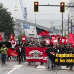 Industrial Workers of the World members walk along Hewitt Avenue in downtown Everett during a march Saturday afternoon to remember the victims of the 1916 Everett Massacre. (Ian Terry / The Herald)