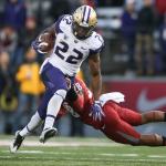 Washington running back Lavon Coleman nearly avoids the tackle by Washington State University&rsquo;s Darius Lemora during the Apple Cup on Friday in Pullman. (Andy Bronson / The Herald)