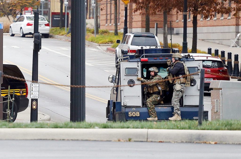 Members of the Columbus SWAT team work the scene around a parking garage after reports of a shooting on the campus of Ohio State University on Monday, Nov. 28, in Columbus, Ohio. (AP Photo/Jay LaPrete)